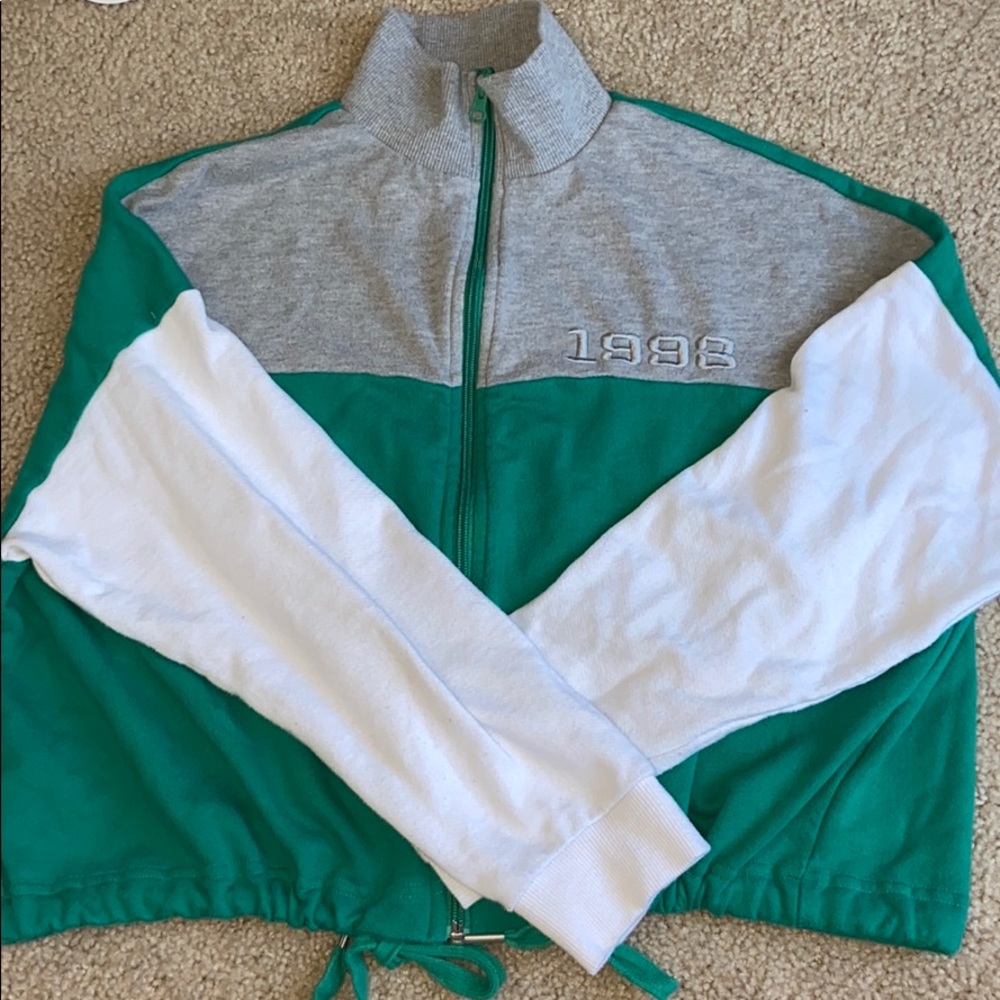 Color-blocked zip up that cinches when tied.